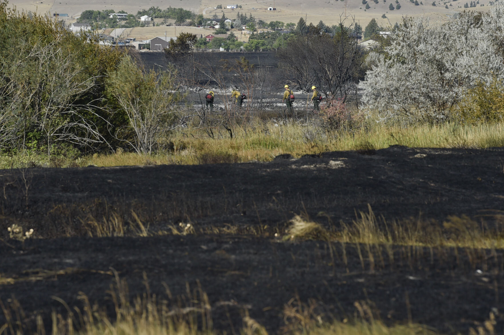 Firefighters mop up along Seven Mile Creek